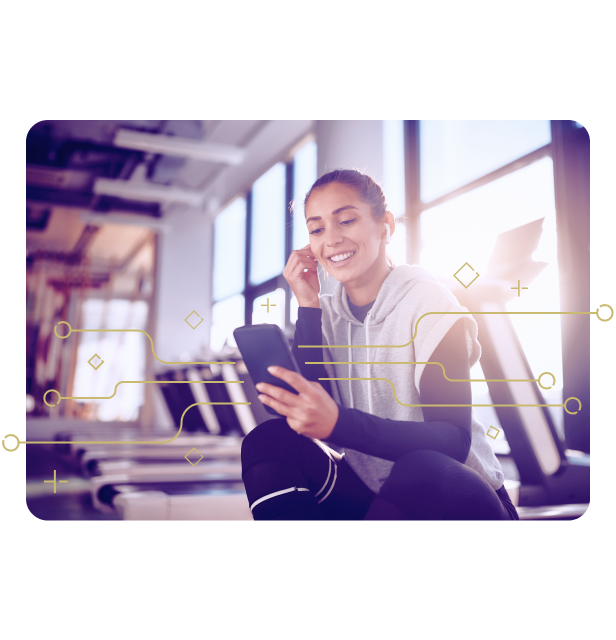 Happy Women in Gym Looking at Phone